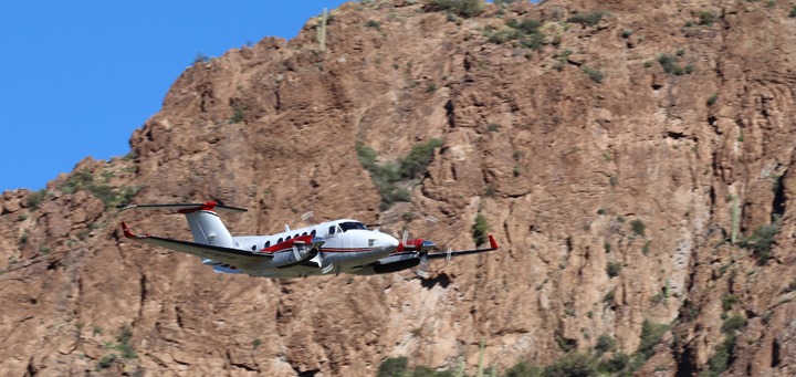U.S. Forest Service King Air plane flying a mission.