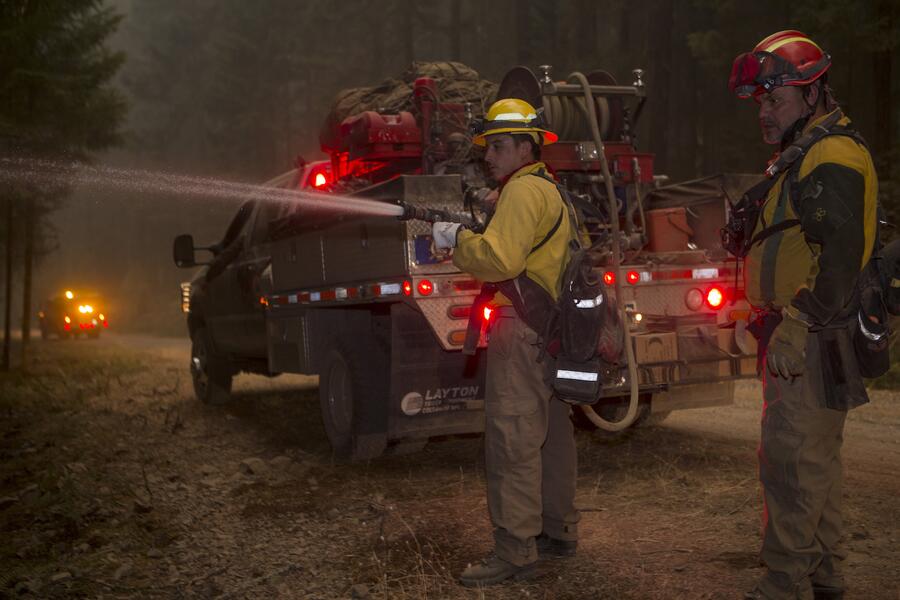 An engine crew works to put out a wildfire