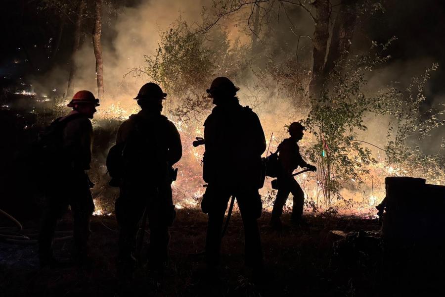 Firefighters work the fireline at night on the Green Fire in California.
